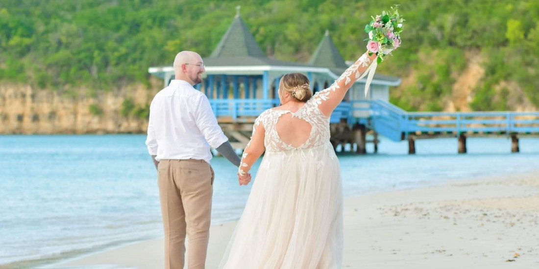 A couple walks hand-in-hand along a tropical beach, their joy palpable.