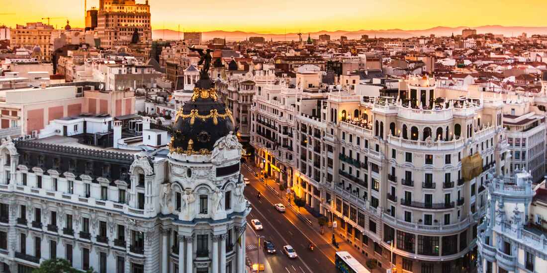As the sun sets over Gran V&iacute;a, Madrid transforms into a city of light, history, and endless energy.